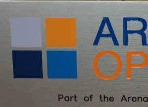 close up of an engraved brushed stainless steel sign which has been painted