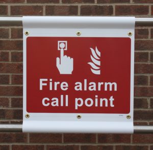 fire alarm call point banner fitted to scaffolding posts